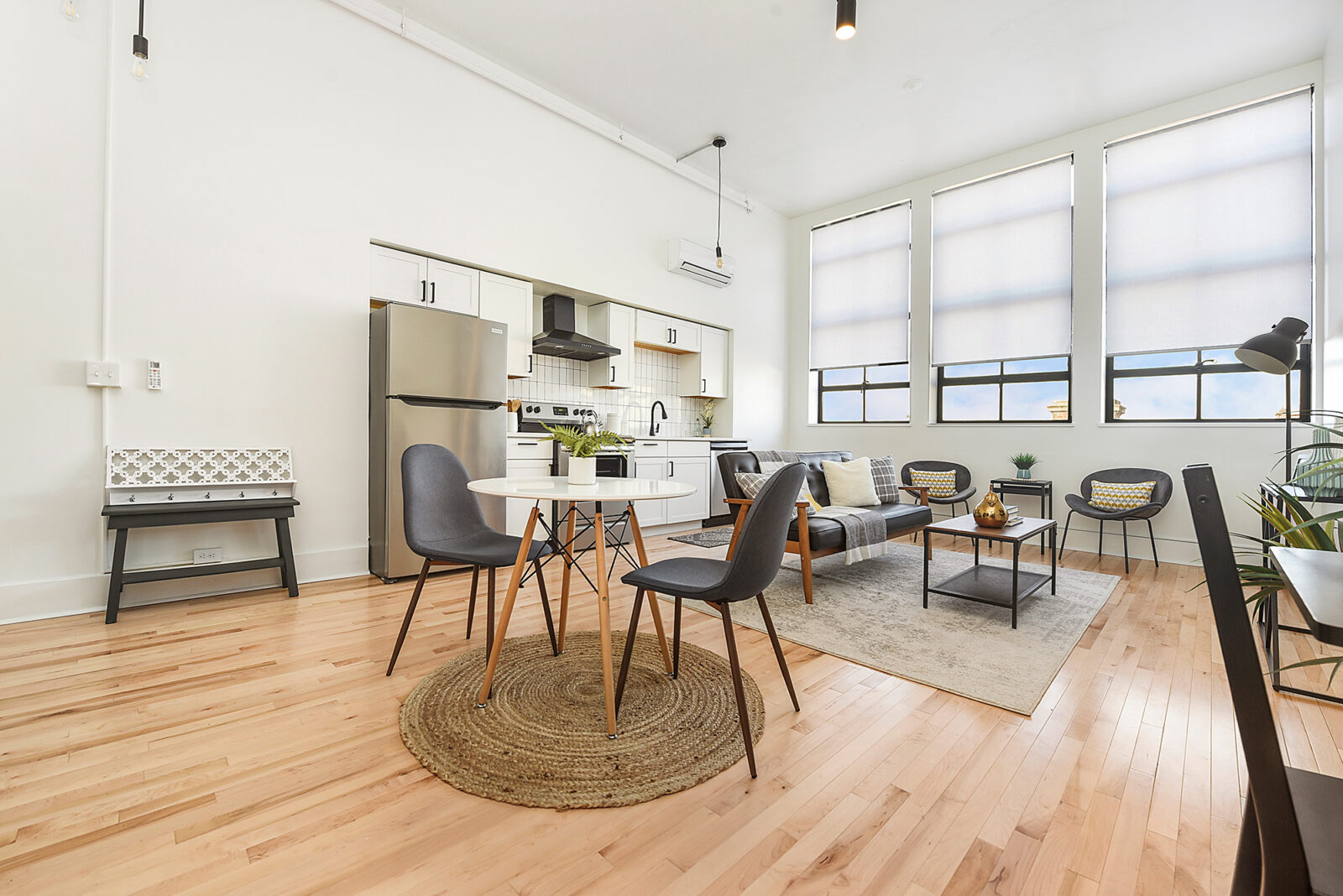 A modern-looking kitchen and dining area with large windows