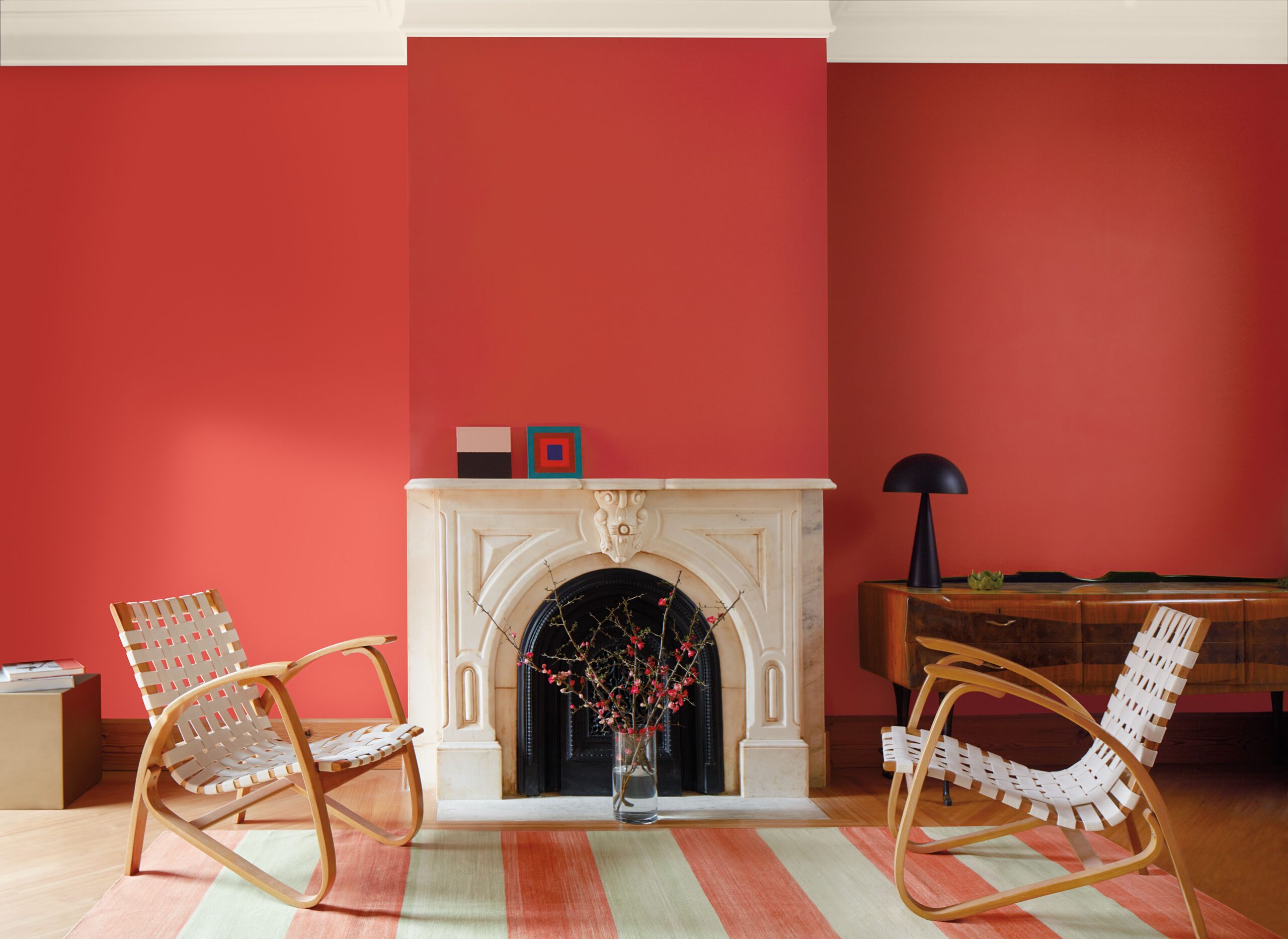 A living room with walls painted in Benjamin Moore 2023 Color of the Year Raspberry Blush